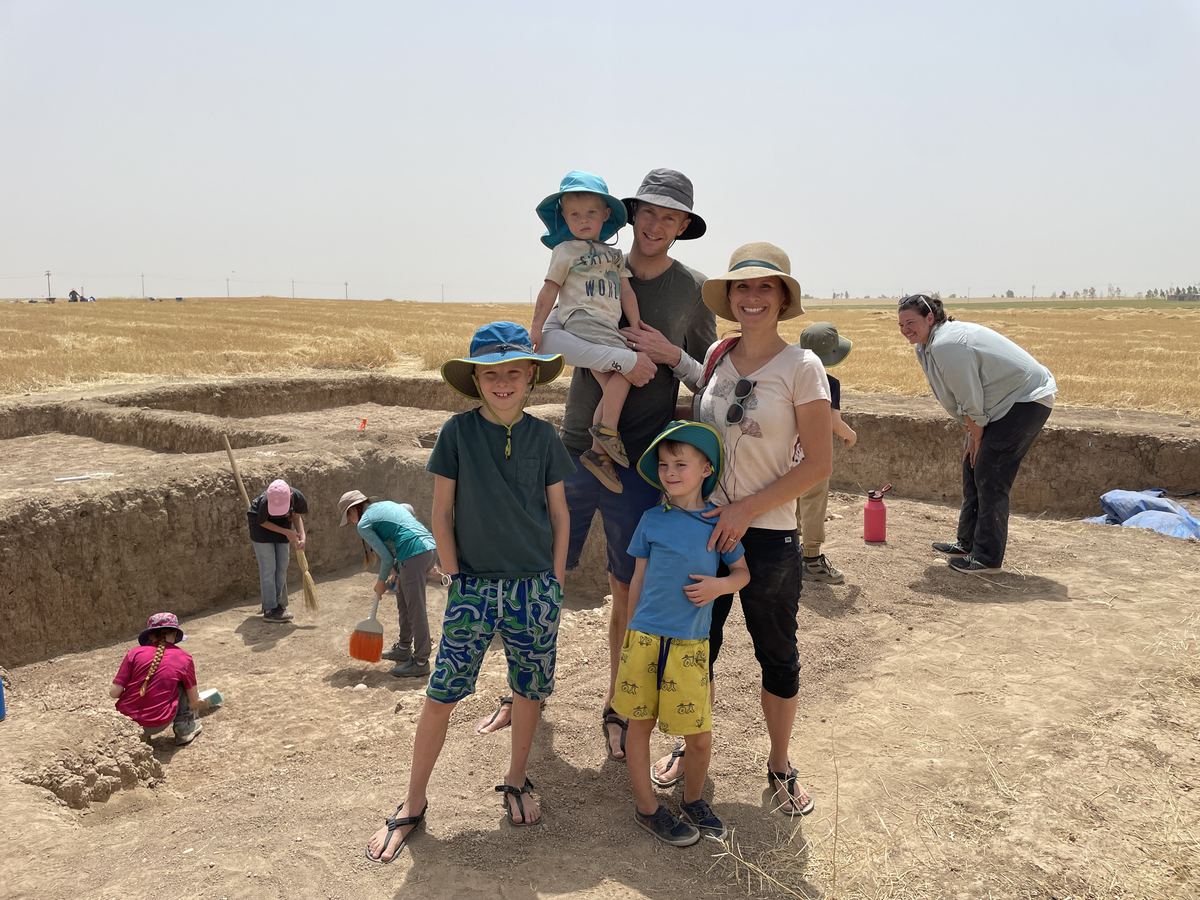 Jamie Watt with his wife and three sons standing in the trenches of an archaeological dig